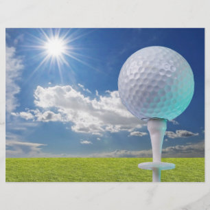golf ball on a tee with grass