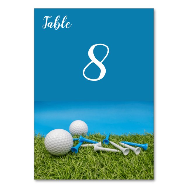Golf ball with tees are on grass and blue colour table number (Front)