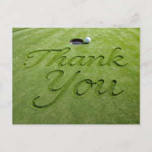 Golf ball with text Thank you on green grass Postcard