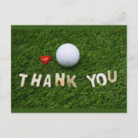 Golf ball with thank you word on green grass