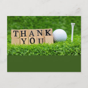 Golf ball with thank you word on green grass  postcard