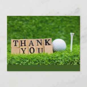 Golf ball with thank you  word on green grass  postcard