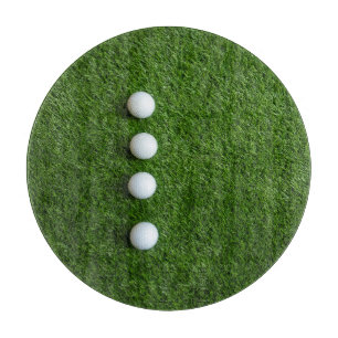 Golf Balls are on green grass Cutting Board
