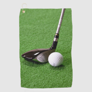 Golf club and ball on a green surface Golf Towels