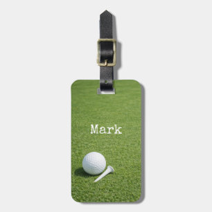 Golfer bag tag with golf ball  at hole