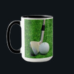 Golfing Sport golf ball and putter Personalise  Mug<br><div class="desc">A coffee mug for any golf enthusiast. The design features a putter poised next to a golf ball ready to sink the ball into the cup. Personalise it with a name on the green. The name text is easily changed (or removed) by using the template. If other changes are desired...</div>