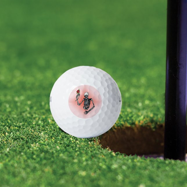 Gothic Skeleton Single Red Rose Golf Balls (Skeleton holding single red rose on stem on pink background on golf balls.)