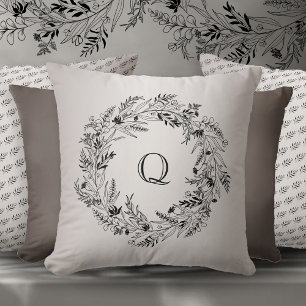 Graceful black foliage circle letter Q Cushion