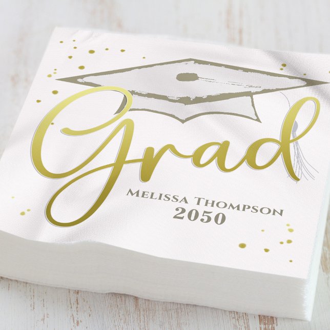 Graduate Grad Gold Calligraphy Graduation Cap Napkin (Gold graduation cocktail napkins displayed beside drinks at a black and gold party table)