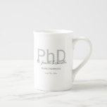 Graduate Keepsake Black Grey Name PhD Graduation Bone China Mug<br><div class="desc">A PhD graduation bone China mug that features the graduate’s name, field of study, and graduation date. The mug includes the name in a handwriting script font and a black and grey design. It’s great as a keepsake or a party favour. Simply add the graduate’s info, add this mug to...</div>