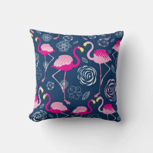 Graphic pattern of pink flamingos on a dark blue b cushion