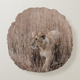 GRAY AND BROWN LION SURROUNDED BY BROWN GRASS ROUND CUSHION