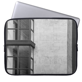 GRAY CONCRETE BUILDING WITH GLASS WINDOW LAPTOP SLEEVE