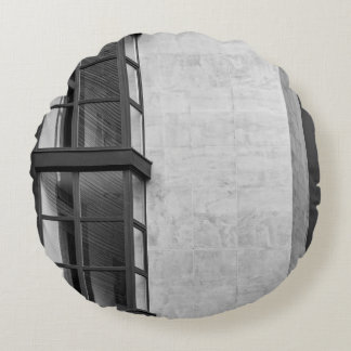 GRAY CONCRETE BUILDING WITH GLASS WINDOW ROUND CUSHION