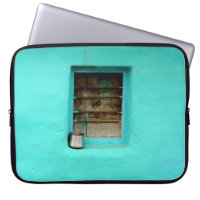 GRAY STEEL CONTAINER ON WINDOW WITH TEAL PAINT