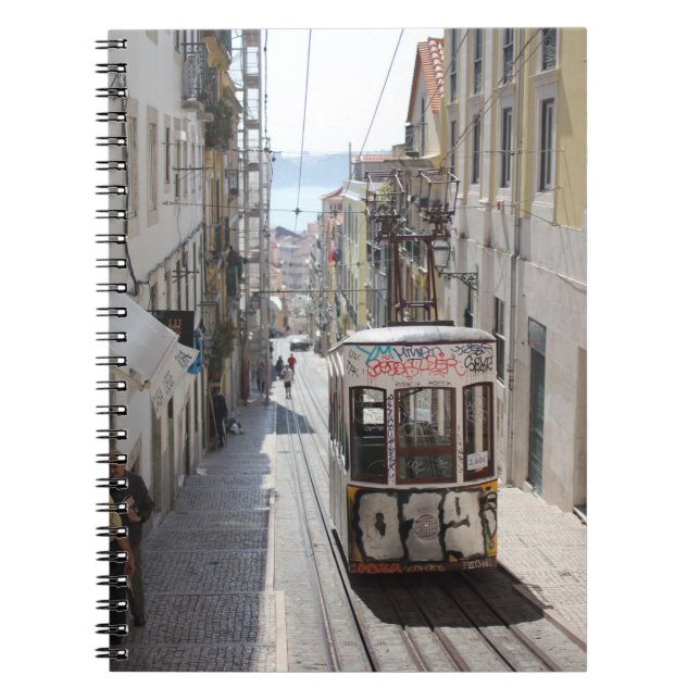 GRAY TRAM ON RAILWAY ALONG THE BUILDING NOTEBOOK (Front)