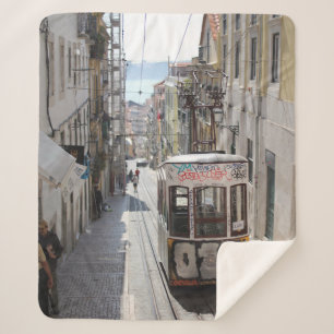 GRAY TRAM ON RAILWAY ALONG THE BUILDING SHERPA BLANKET