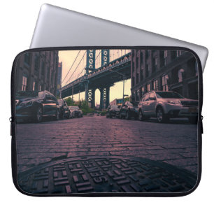 GRAY VEHICLE AT ROAD BESIDE CONCRETE BUILDING LAPTOP SLEEVE