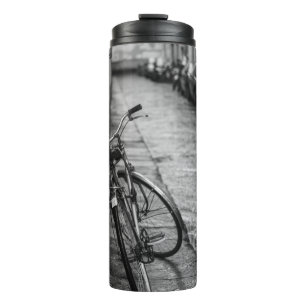 GRAYSCALE PHOTO OF BIKE ON WALL THERMAL TUMBLER
