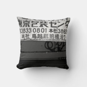 GRAYSCALE PHOTOGRAPHY OF STORE SIGN CUSHION