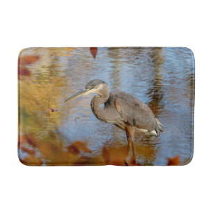 Great Blue Heron framed with fall foliage Bath Mat