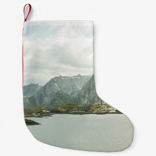 GREEN AND BROWN MOUNTAINS NEAR BODY OF WATER UNDER SMALL CHRISTMAS STOCKING