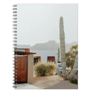 Green cactus beside houses in the morning notebook