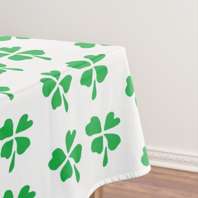 Green clover leaves pattern on white tablecloth (In Situ)