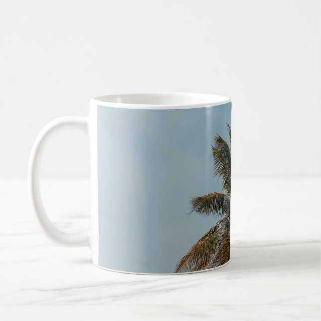 Green coconut tree under blue sky coffee mug (Left)