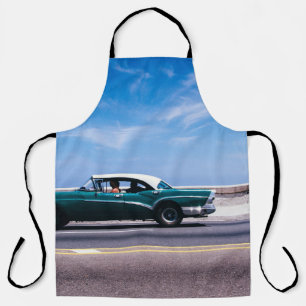 Green coupe on gray asphalt road apron