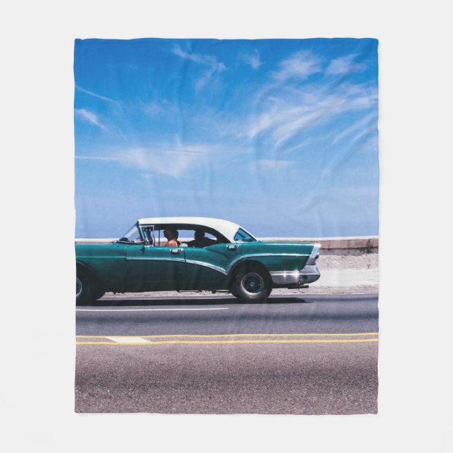 Green coupe on grey asphalt road fleece blanket (Front)