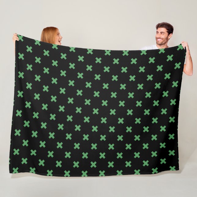 Green cross stitches on black fleece blanket (In Situ)