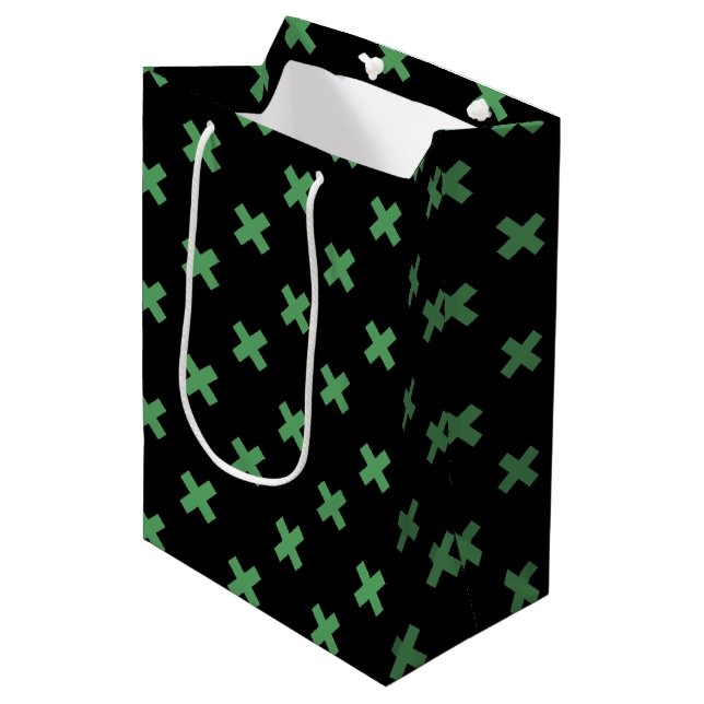 Green cross stitches on black medium gift bag (Front Angled)