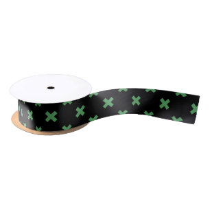 Green cross stitches on black satin ribbon