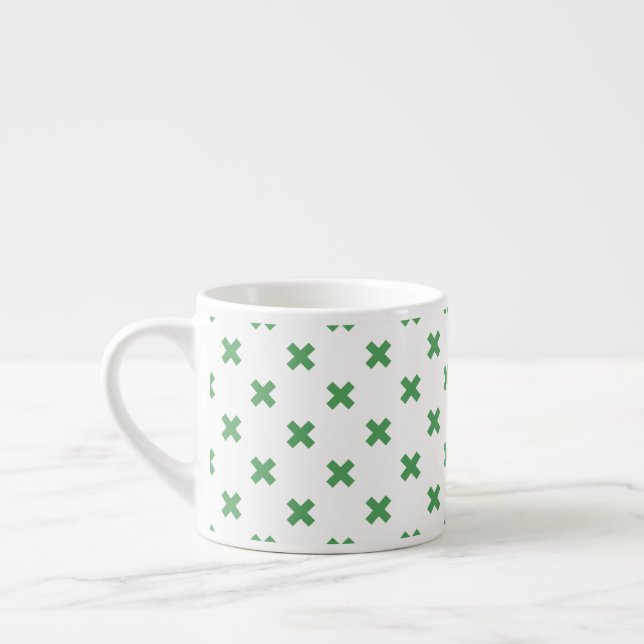 Green cross stitches on white espresso cup (Left)