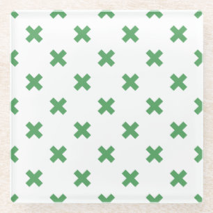 Green cross stitches on white glass coaster