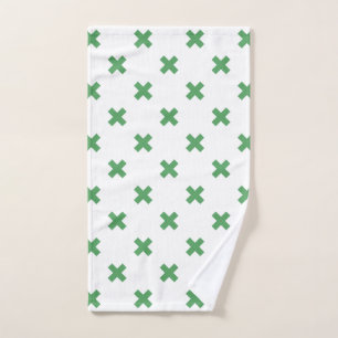 Green cross stitches on white hand towel
