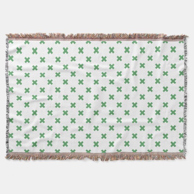 Green cross stitches on white throw blanket (Front)