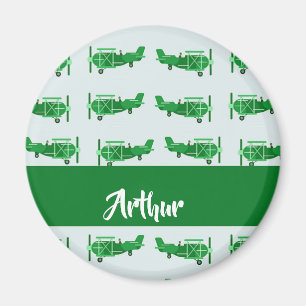 Green flying aeroplanes on blue magnet