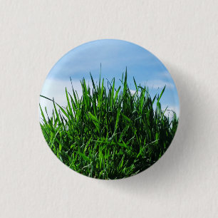 Green grass against the background of the endless 3 cm round badge