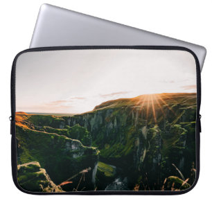 GREEN GRASS FIELD AND MOUNTAIN DURING DAYTIME LAPTOP SLEEVE