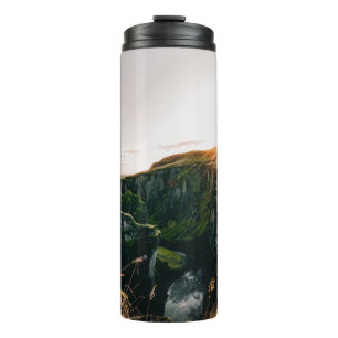 GREEN GRASS FIELD AND MOUNTAIN DURING DAYTIME THERMAL TUMBLER