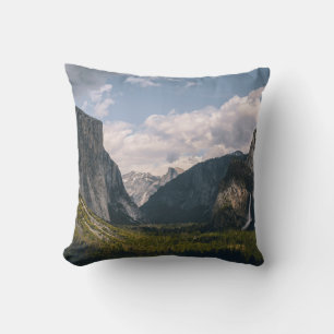 GREEN GRASS FIELD NEAR ROCKY MOUNTAIN UNDER WHITE CUSHION
