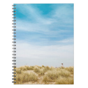 Green grass field under blue skies notebook
