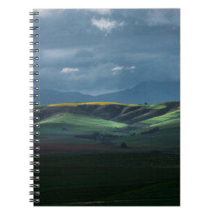 GREEN GRASS FIELD UNDER CLOUDY SKY DURING DAYTIME NOTEBOOK