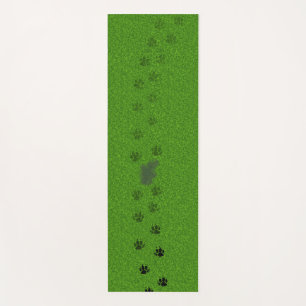 Green grass with dog paw prints and a pee stain yo yoga mat