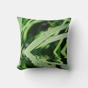 Green grass with drops of dew reflecting in water cushion