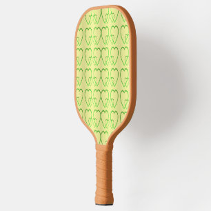 Green hearts on yellow pickleball paddle