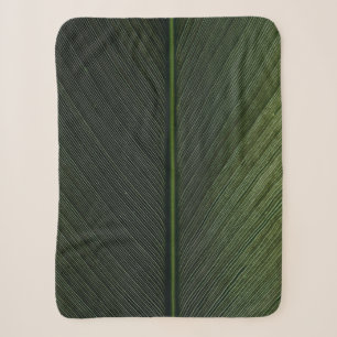 Green metal rod on black and white pinstripe texti sherpa blanket