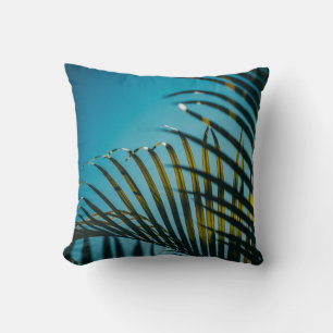 Green palm plant under blue sky in the morning cushion